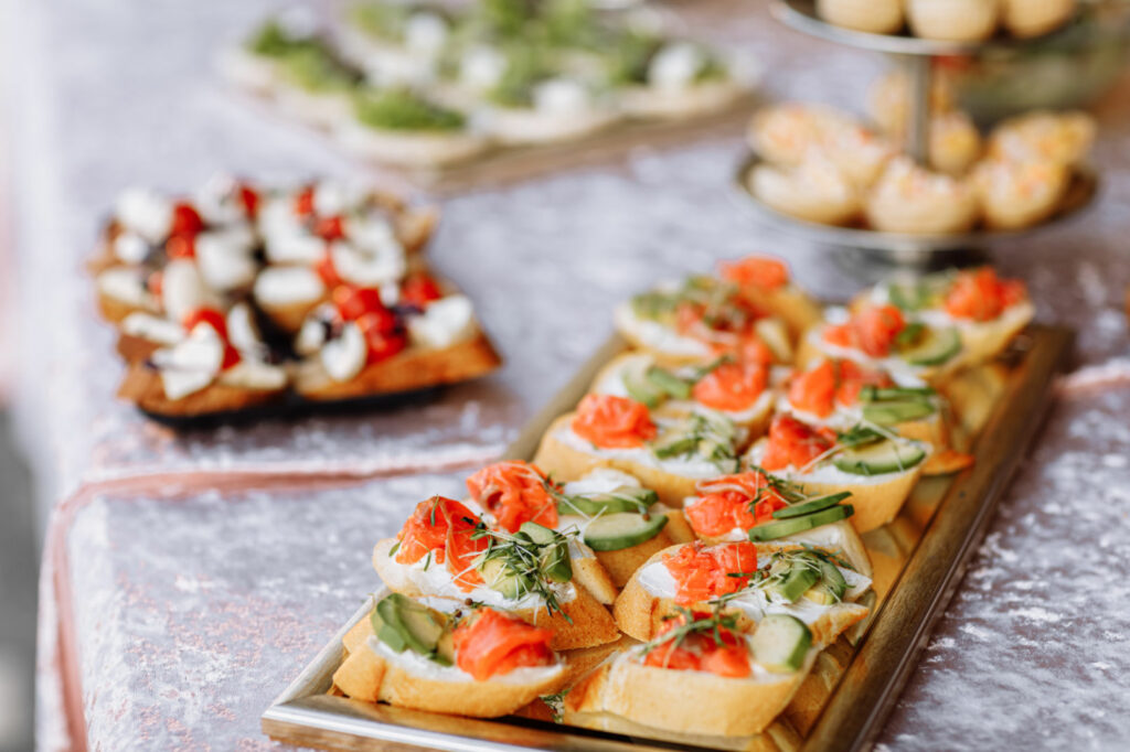 snack. bruschetta with salmon, avocado and microgreen sprouts on a wooden plate