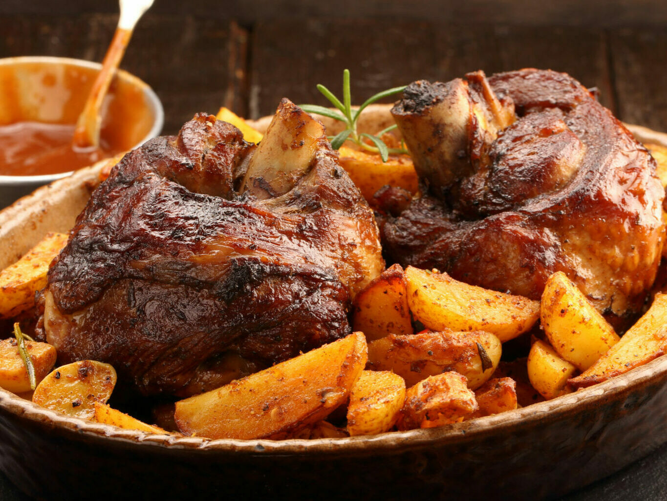 grilled barbecue meat with baked potato and dip